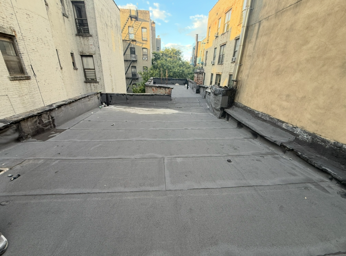 Damaged flat roof before replacement in Queens NYC