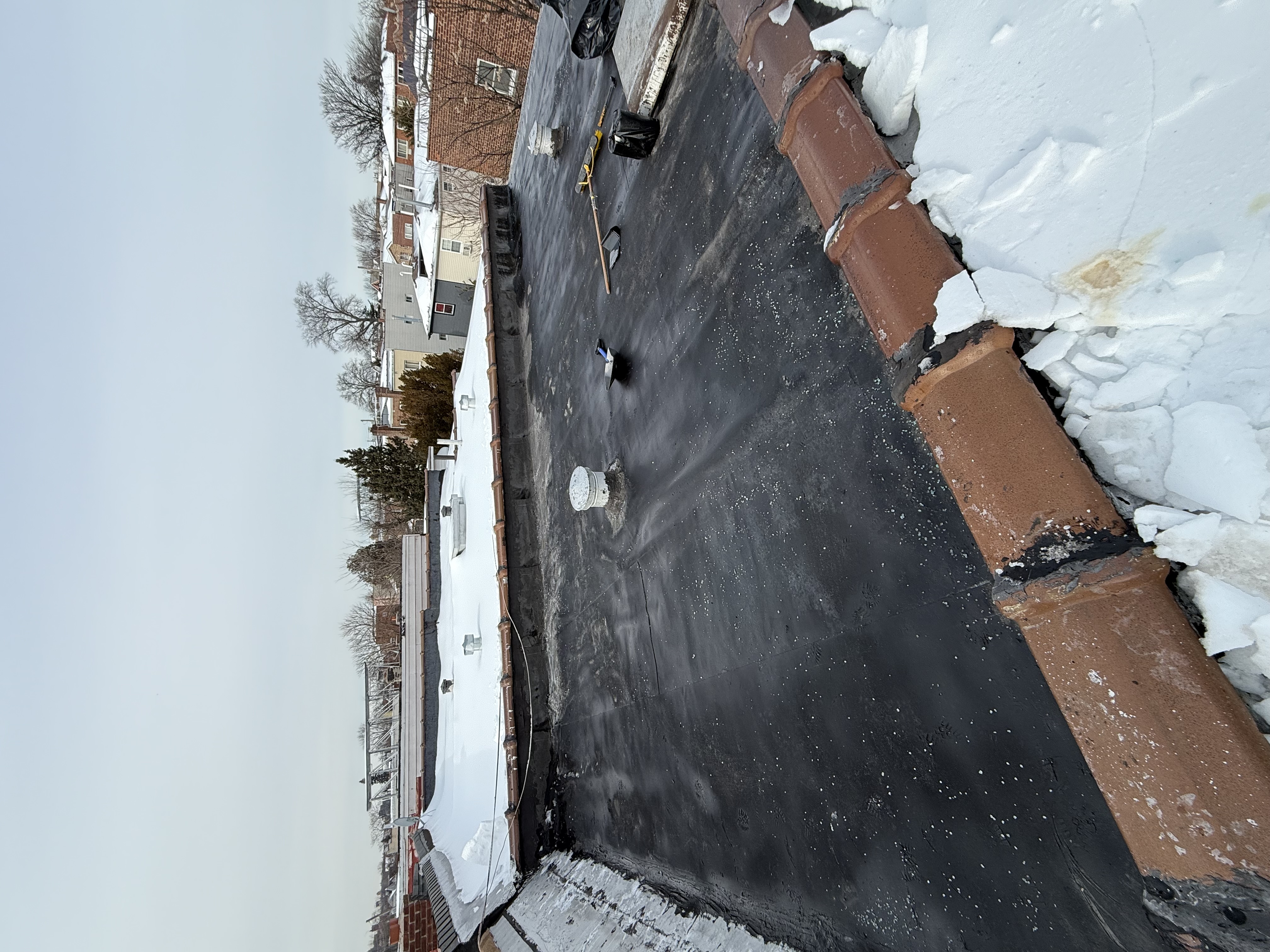 Flat roof snow and ice removal service in Queens by SwiftBuild Construction