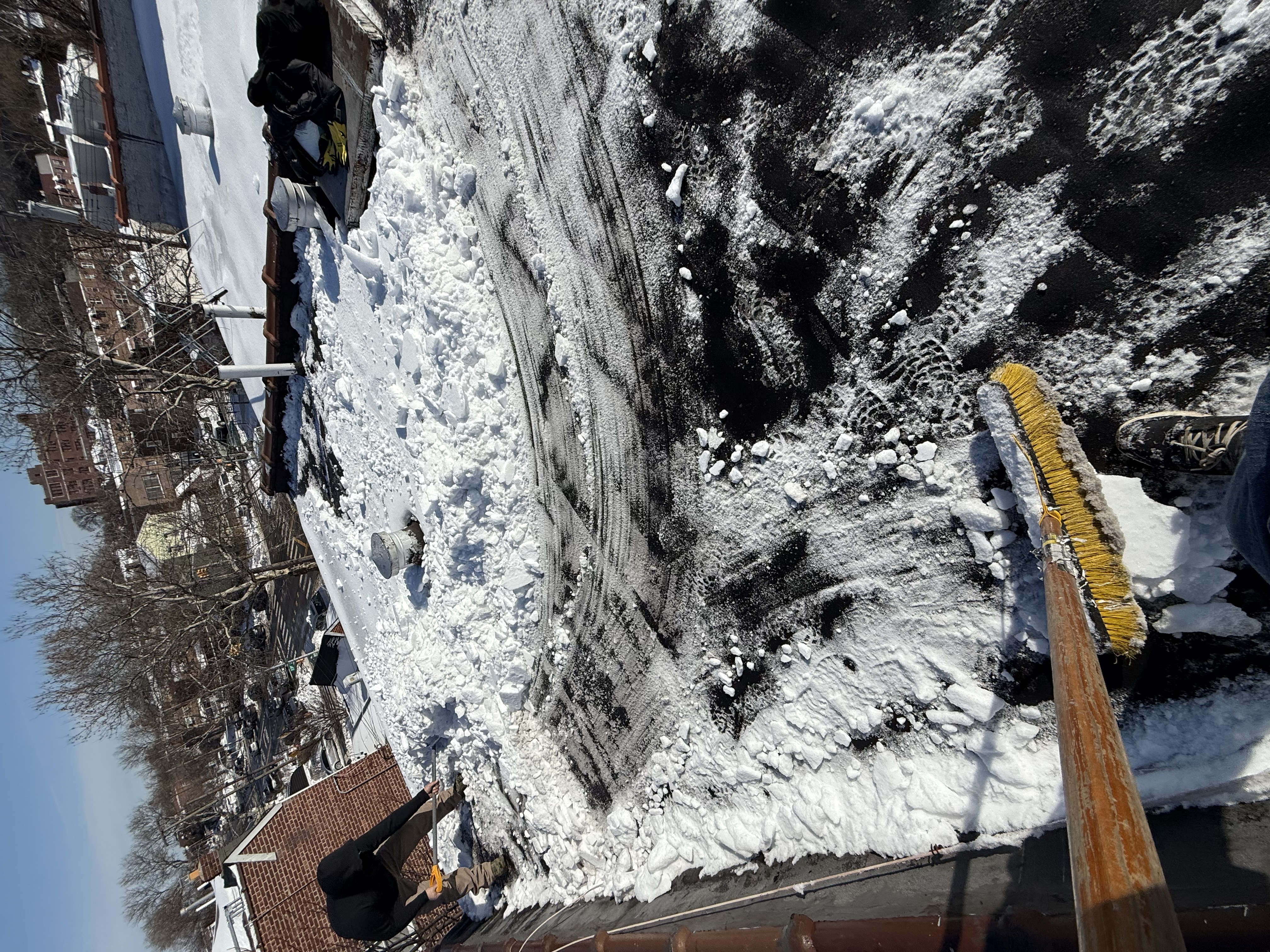 Process of removing snow from a flat roof in Queens NY